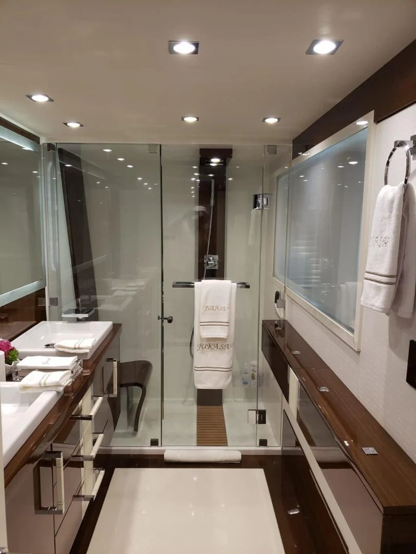 a bathroom with a glass shower aboard CHAPTER II Yacht for Sale