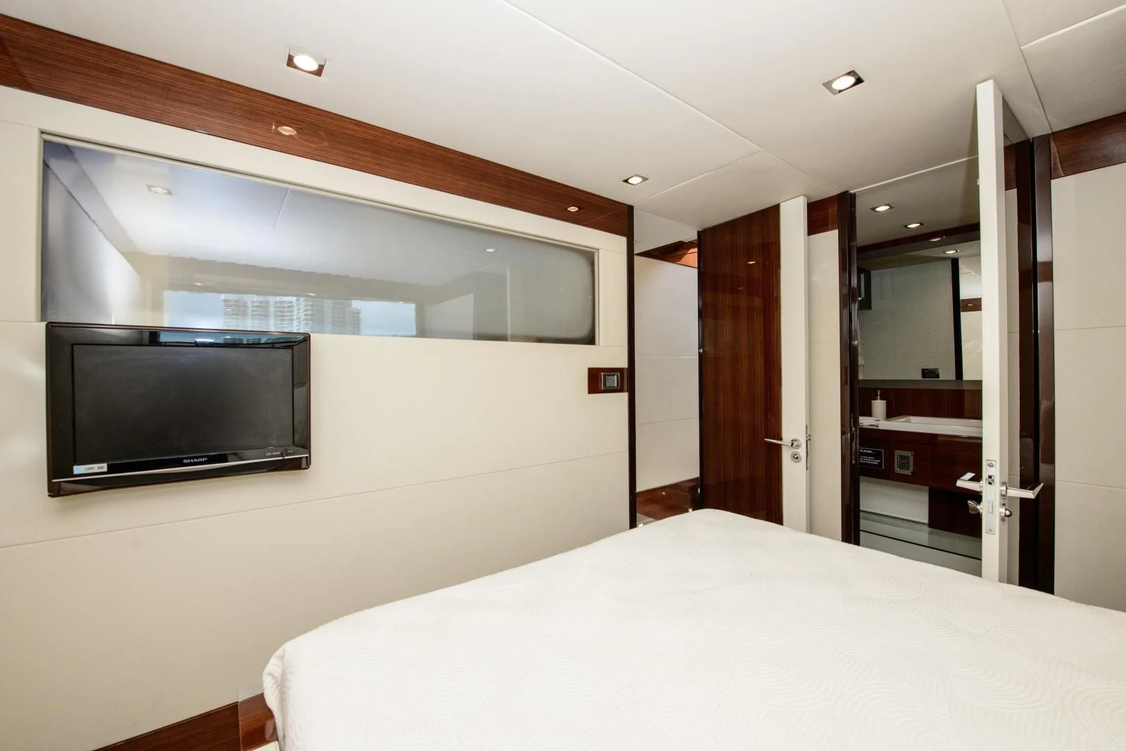 a hotel room with a bed and tv aboard CHAPTER II Yacht for Sale