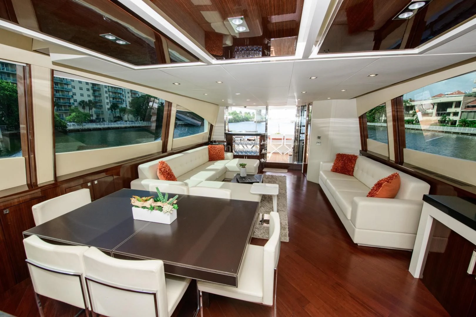 a living room with a large table and couches aboard CHAPTER II Yacht for Sale