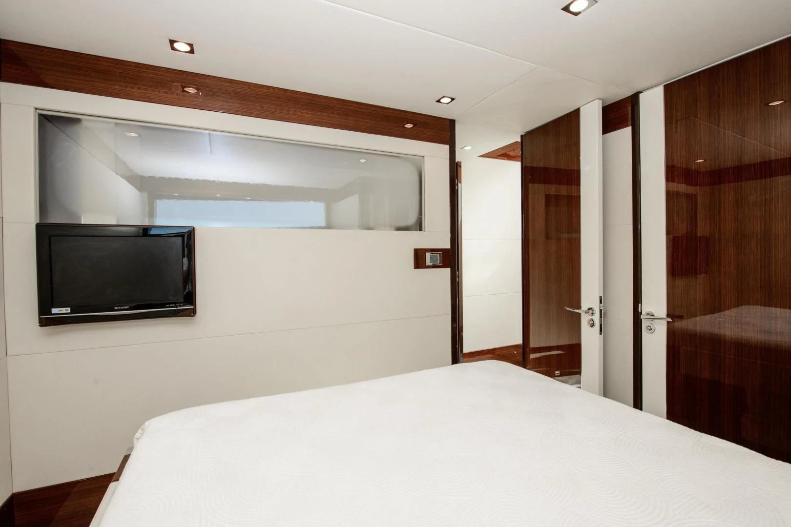 a hotel room with a bed and tv aboard CHAPTER II Yacht for Sale