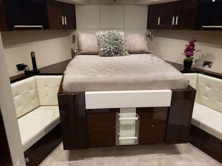 a bed with a white cover aboard CHAPTER II Yacht for Sale