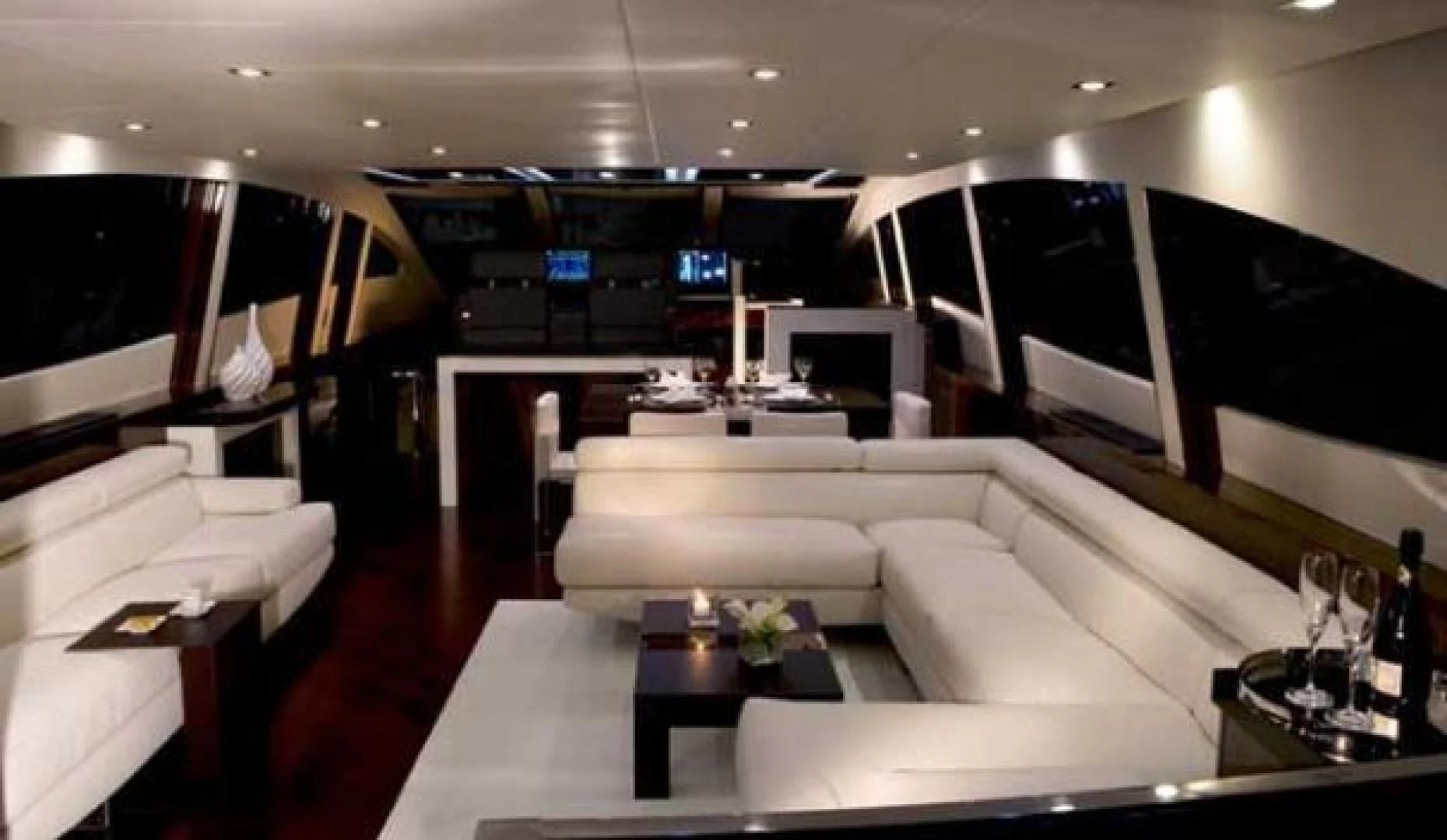 a room with a couch and a table with a glass of wine aboard CHAPTER II Yacht for Sale