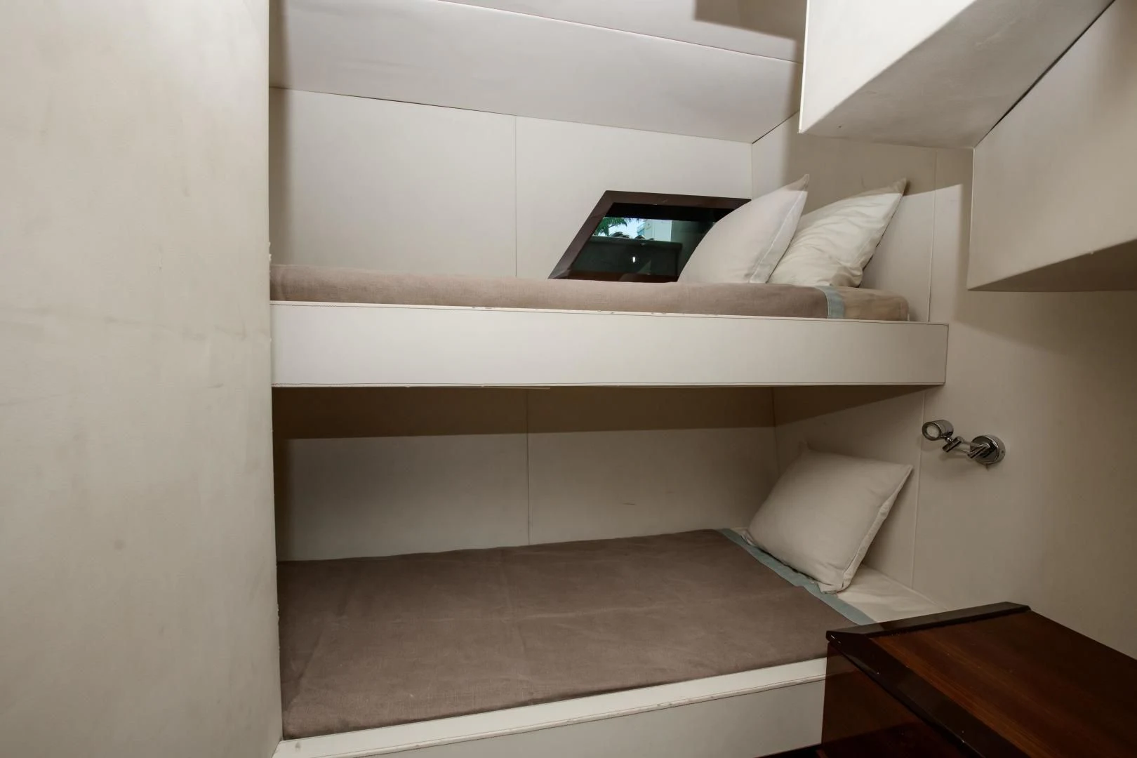 a white bed with a laptop on it aboard CHAPTER II Yacht for Sale