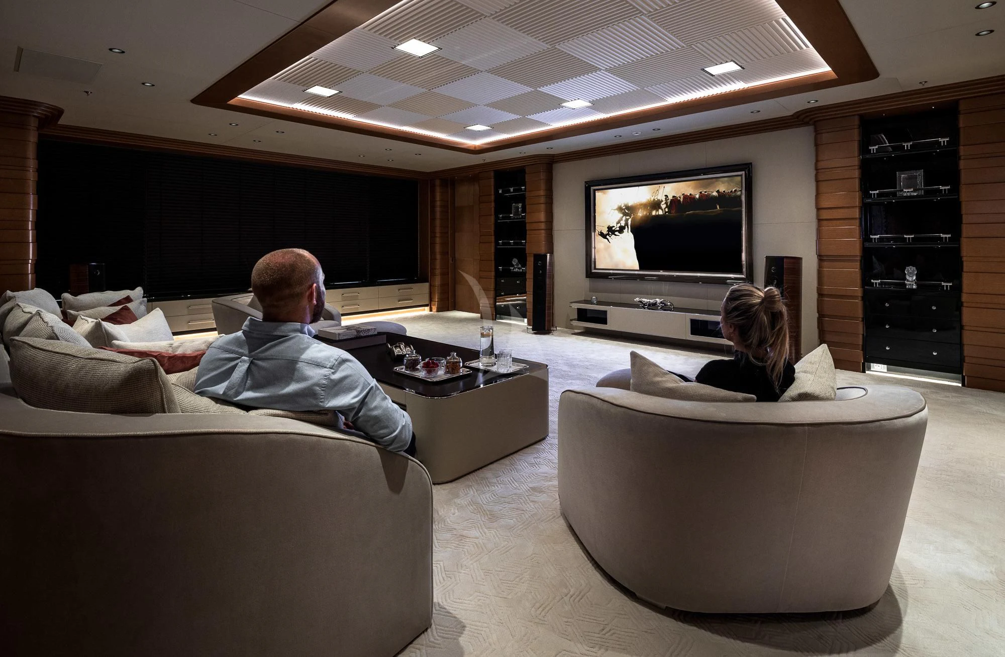 a man and woman sitting on a couch watching television aboard MAR Yacht for Sale