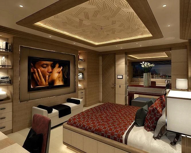 a tv on a wall in a room with a bed and a table aboard MAR Yacht for Sale