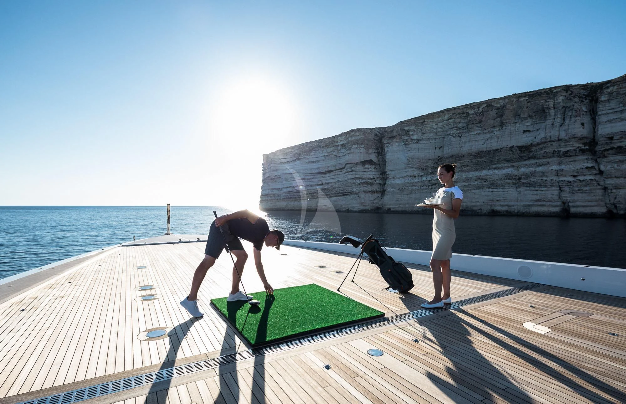 a person playing golf aboard MAR Yacht for Sale