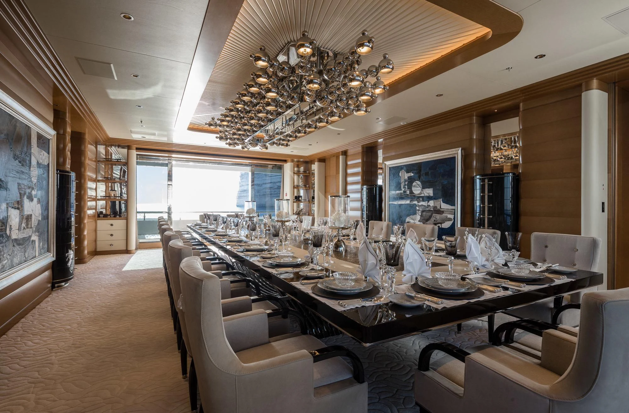 a large dining room with a chandelier aboard MAR Yacht for Sale