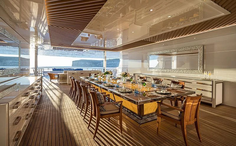 a large room with a table and chairs aboard MAR Yacht for Sale