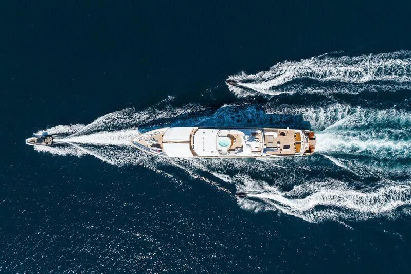 a space shuttle flying over a planet aboard EMERALD Yacht for Charter
