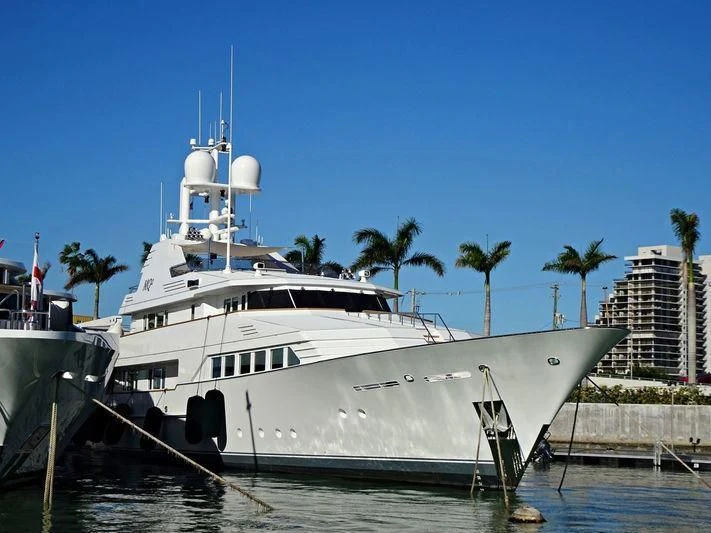 a large white boat in a harbor aboard EMERALD Yacht for Charter
