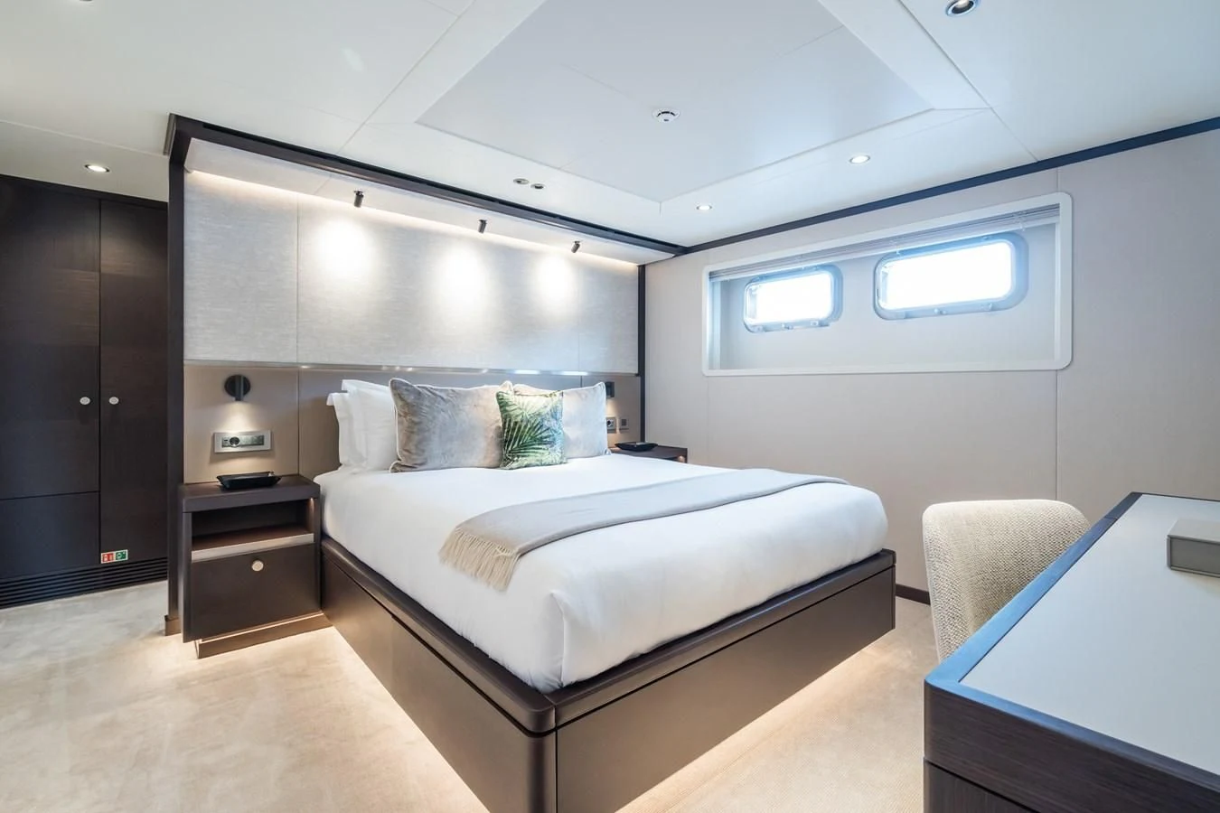a bedroom with a bed and a desk aboard EMERALD Yacht for Charter