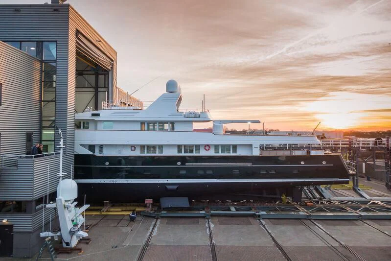 a large ship docked at a pier aboard EMERALD Yacht for Charter