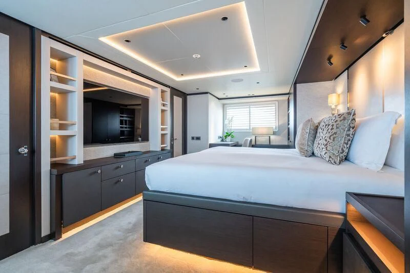 a bedroom with a bed and a desk aboard EMERALD Yacht for Charter