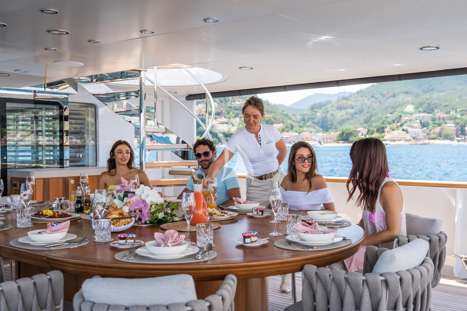 a family sitting at a table aboard EMERALD Yacht for Charter