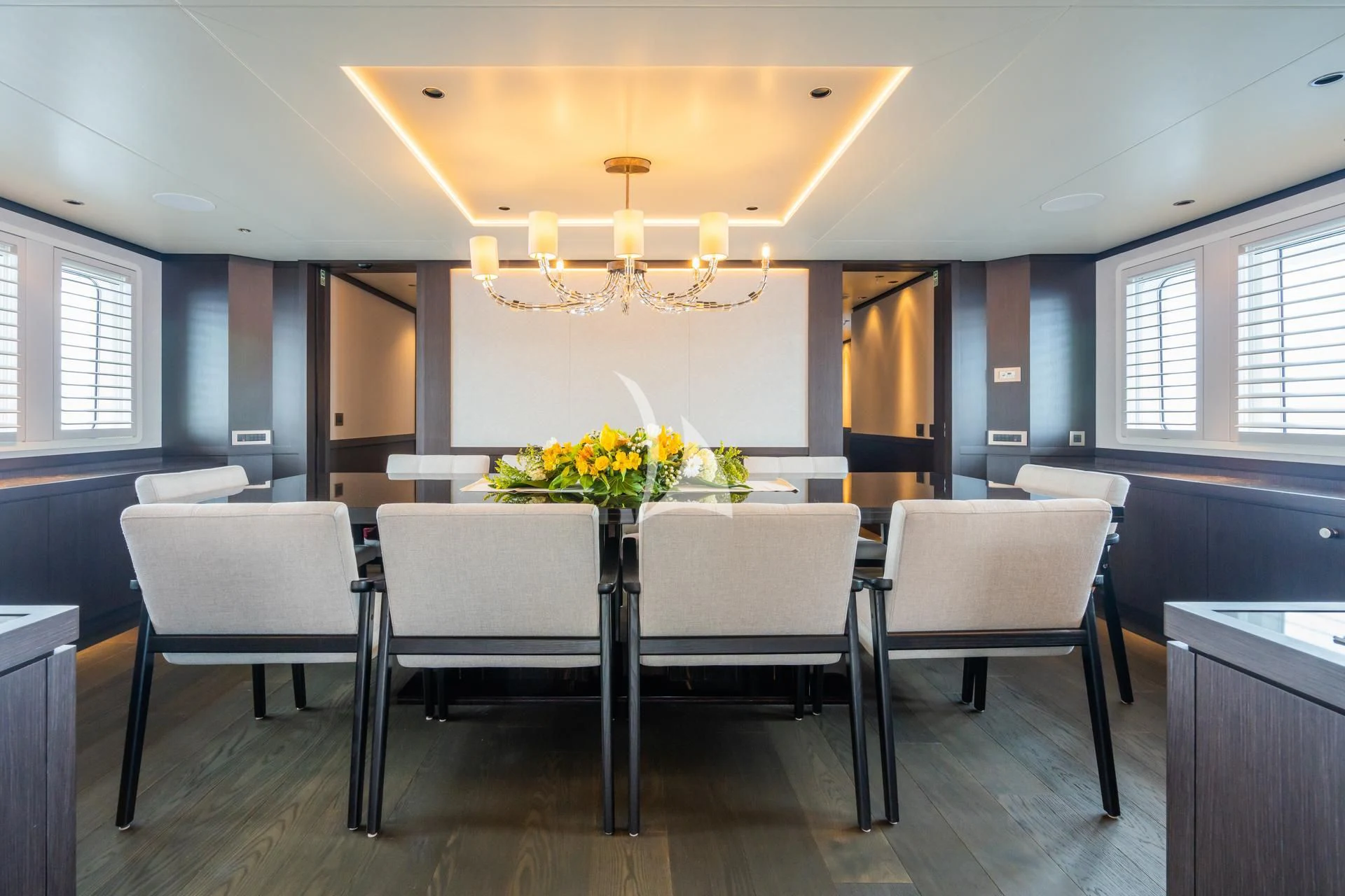 a room with tables and chairs aboard EMERALD Yacht for Charter