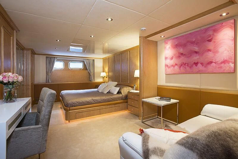 a room with a bed and a couch aboard EMERALD Yacht for Charter