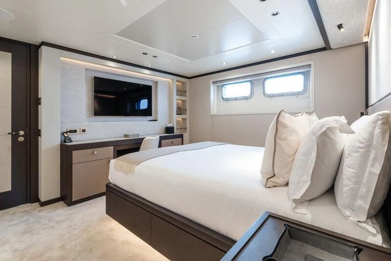 a bedroom with a bed and a television aboard EMERALD Yacht for Charter