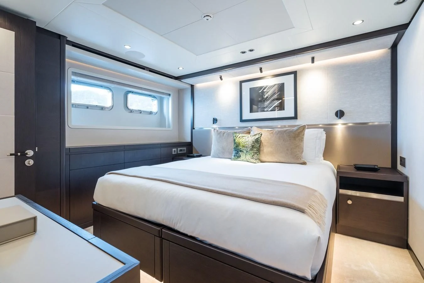 a bedroom with a bed and a desk aboard EMERALD Yacht for Charter