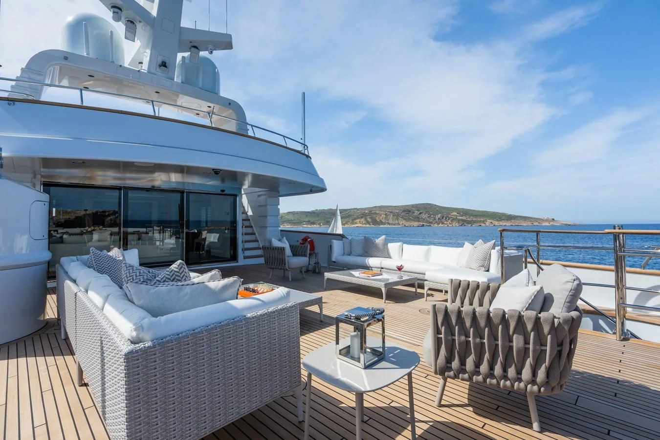 a deck with a table and chairs on it aboard EMERALD Yacht for Charter
