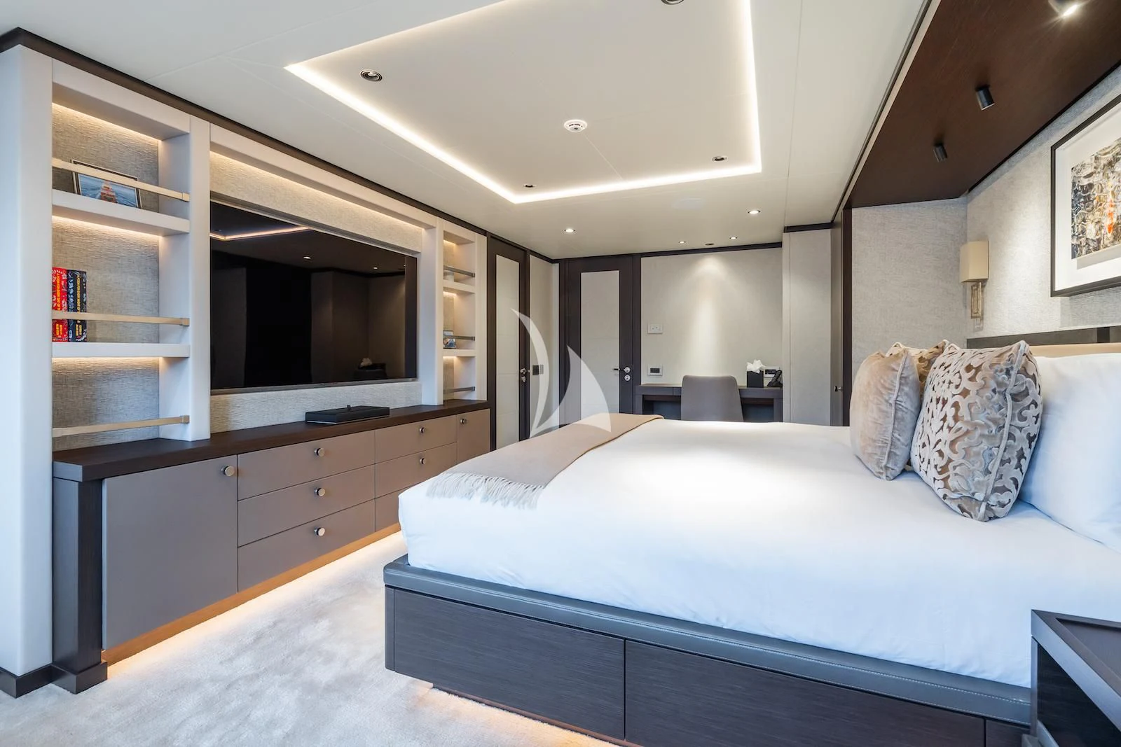 a bedroom with a bed and a television aboard EMERALD Yacht for Charter