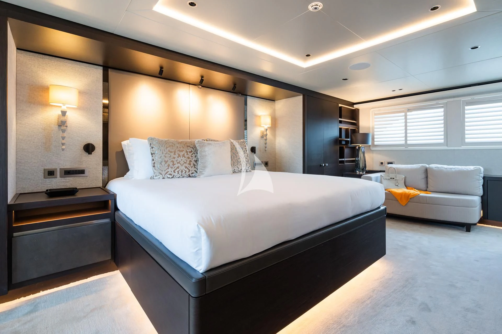 a large bedroom with a bed and a couch aboard EMERALD Yacht for Charter
