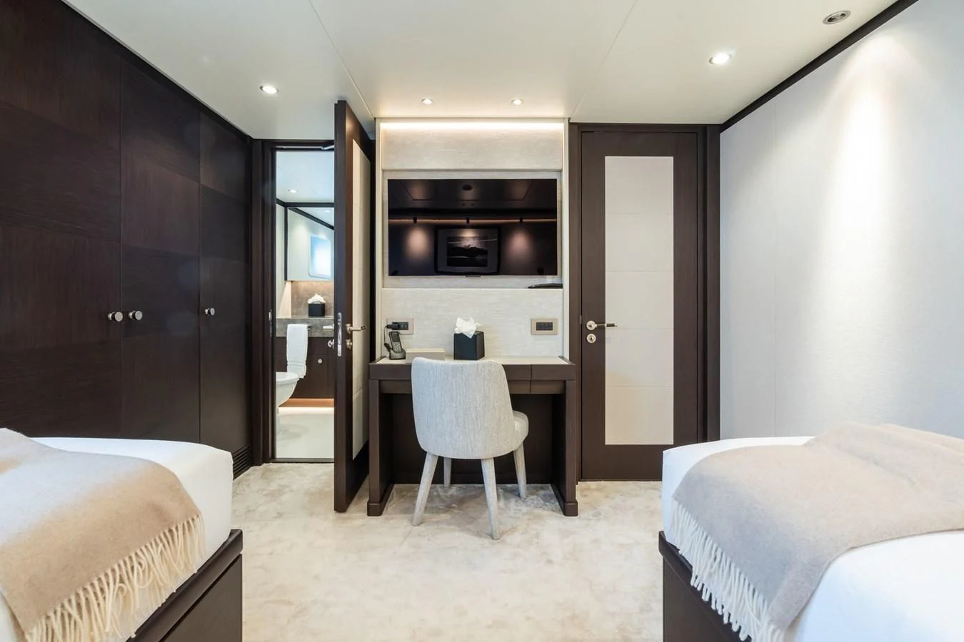 a room with a bed and a desk aboard EMERALD Yacht for Charter