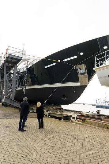 a couple people standing next to a plane aboard EMERALD Yacht for Charter