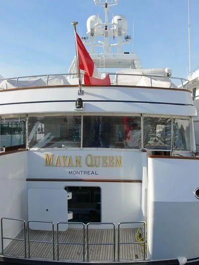 a boat with a flag on the front aboard EMERALD Yacht for Charter
