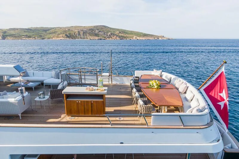 a boat with a flag on the deck aboard EMERALD Yacht for Charter