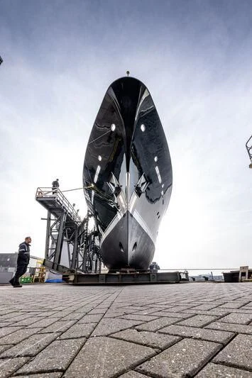 a large metal object with a man standing next to it aboard EMERALD Yacht for Charter