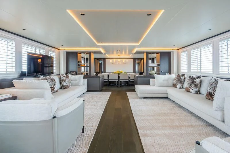 a living room with white couches aboard EMERALD Yacht for Charter