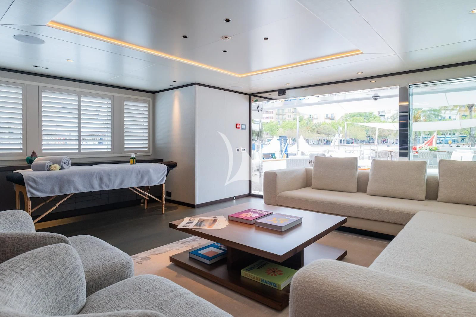 a bedroom with a bed and a table aboard EMERALD Yacht for Charter