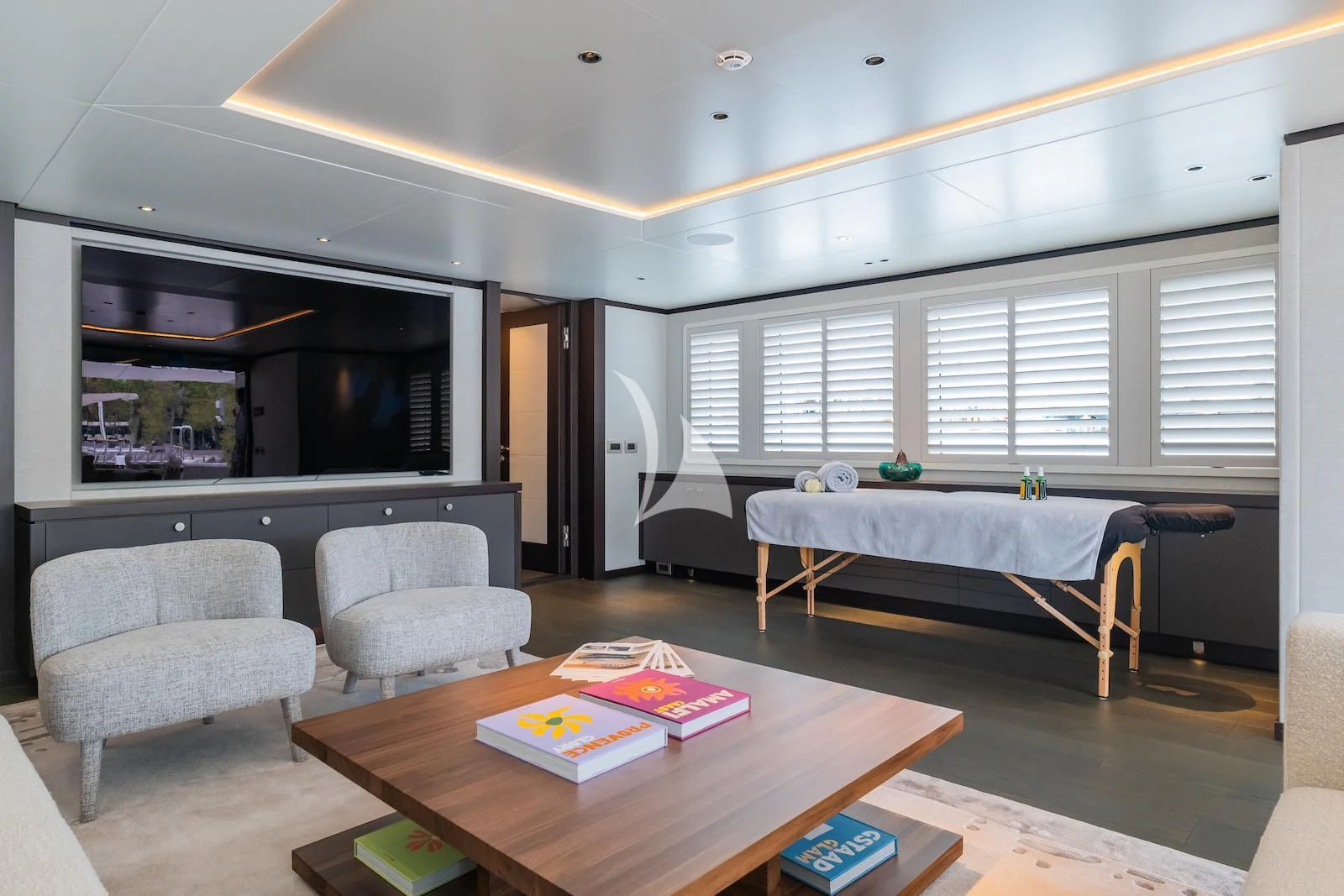 a bedroom with a bed and a table aboard EMERALD Yacht for Charter