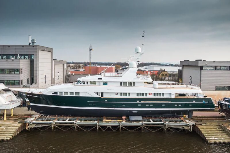 a large white boat in a harbor aboard EMERALD Yacht for Charter