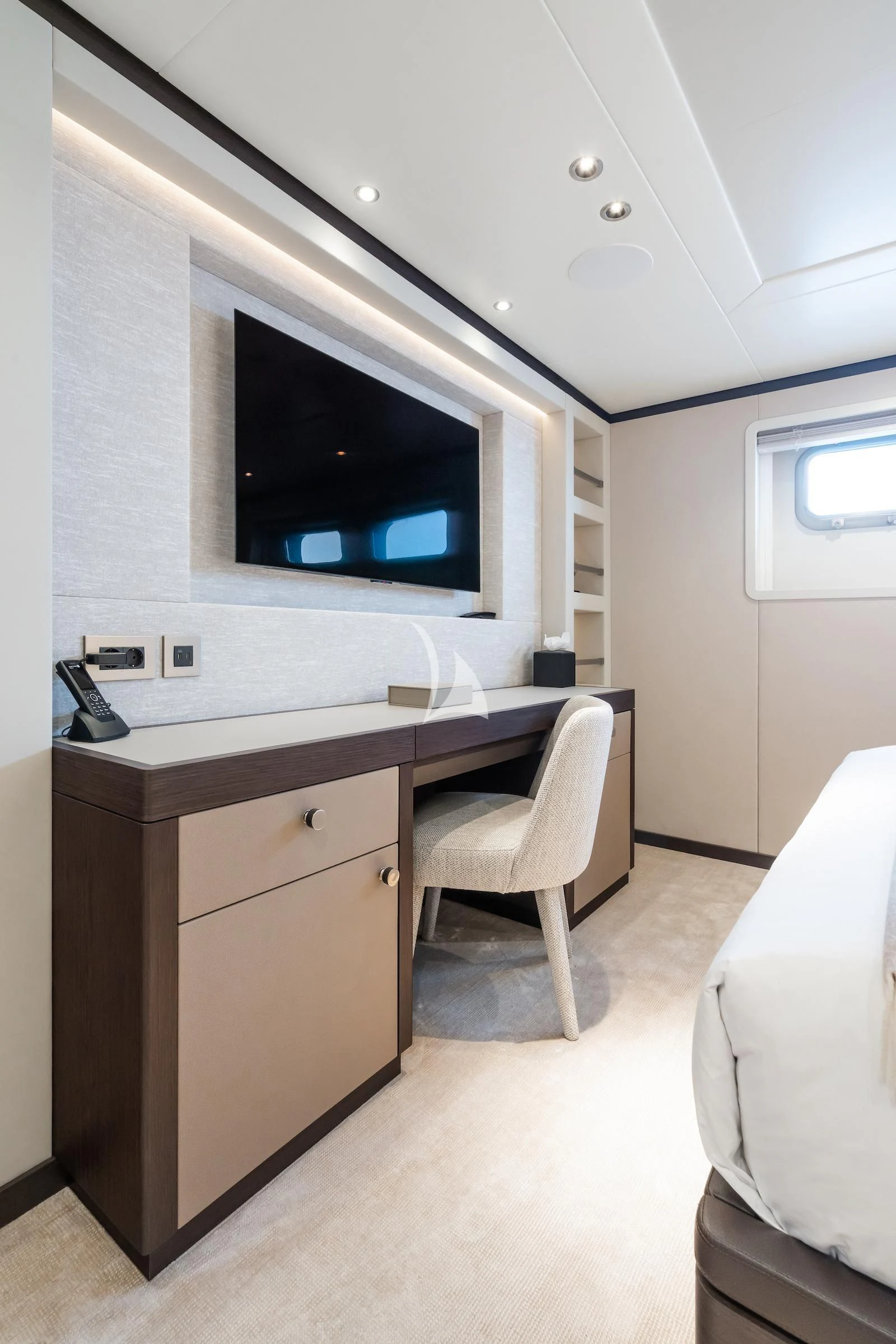 a room with a tv and a chair aboard EMERALD Yacht for Charter