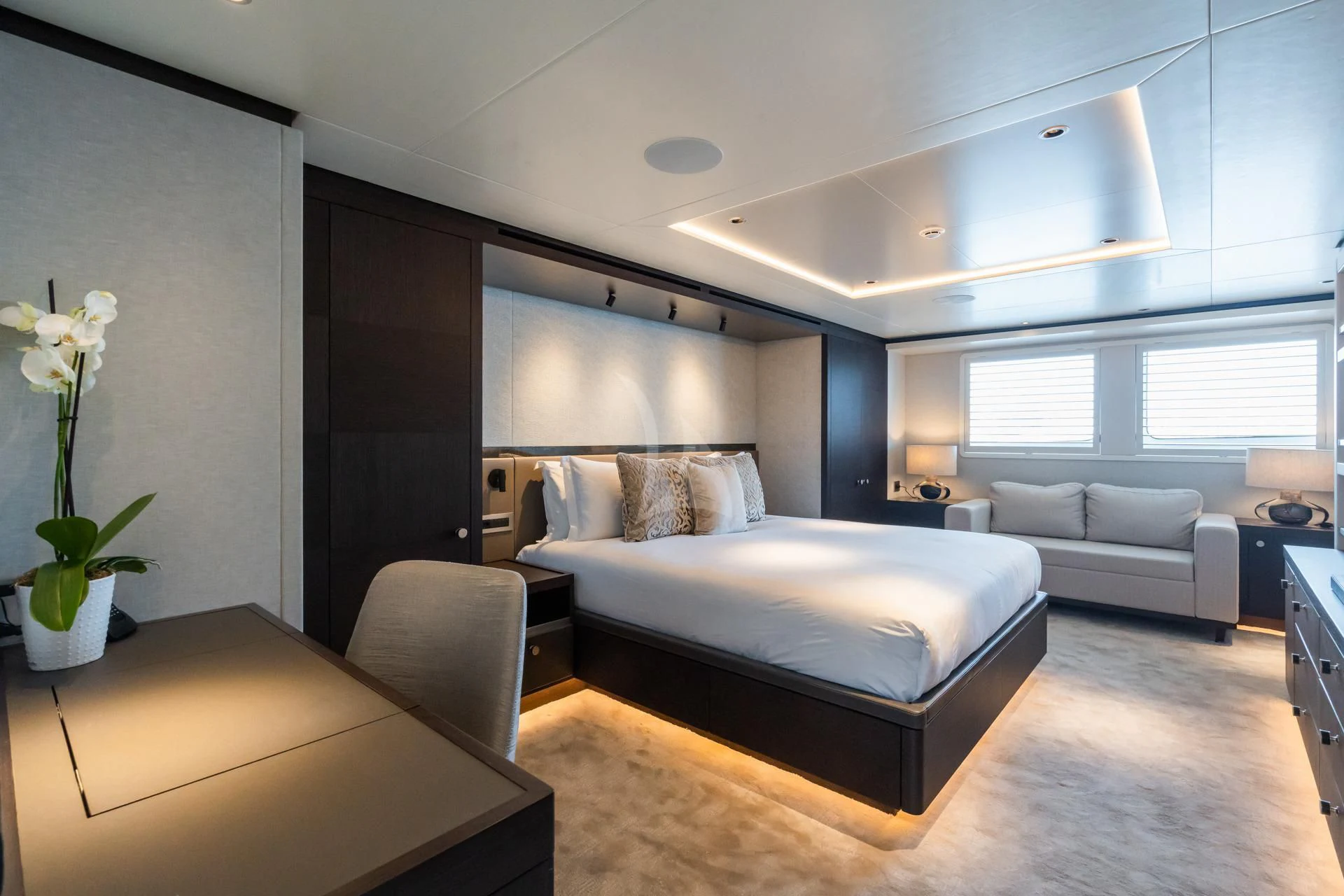 a modern bedroom with a bed and a couch aboard EMERALD Yacht for Charter