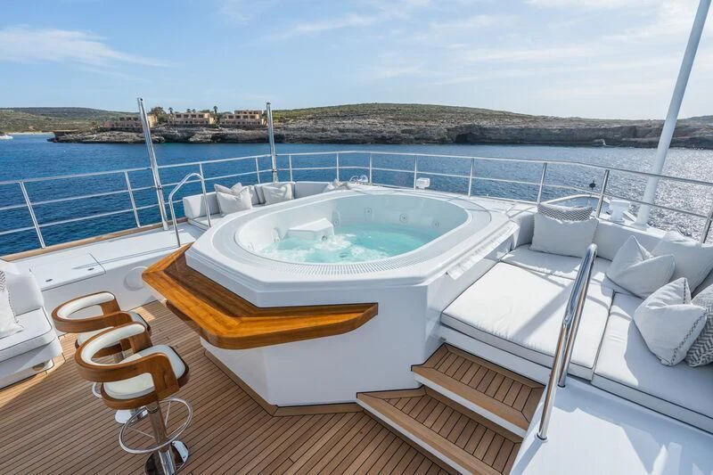 a large white tub on a deck overlooking a body of water aboard EMERALD Yacht for Charter