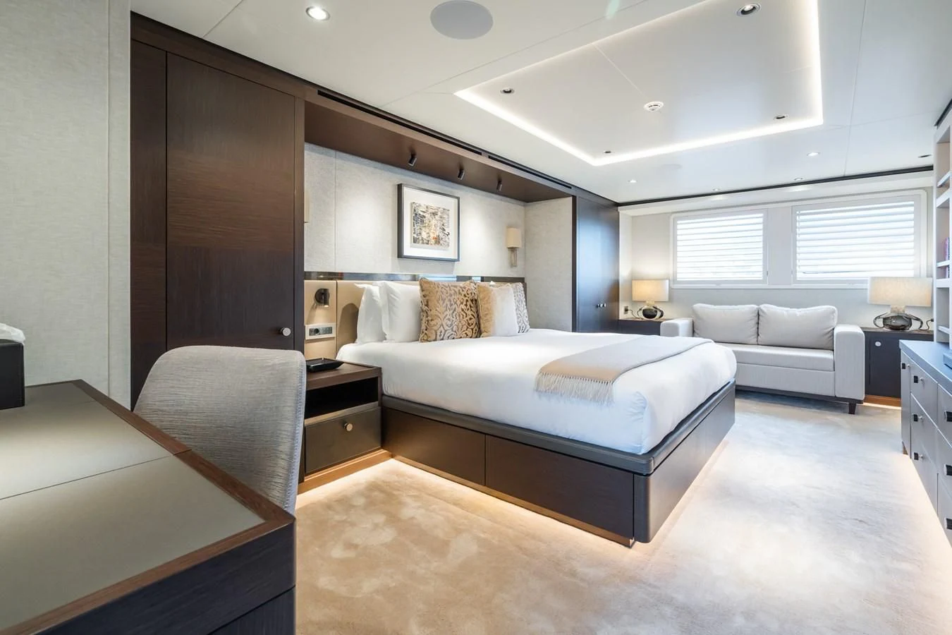 a bedroom with a bed and a couch aboard EMERALD Yacht for Charter