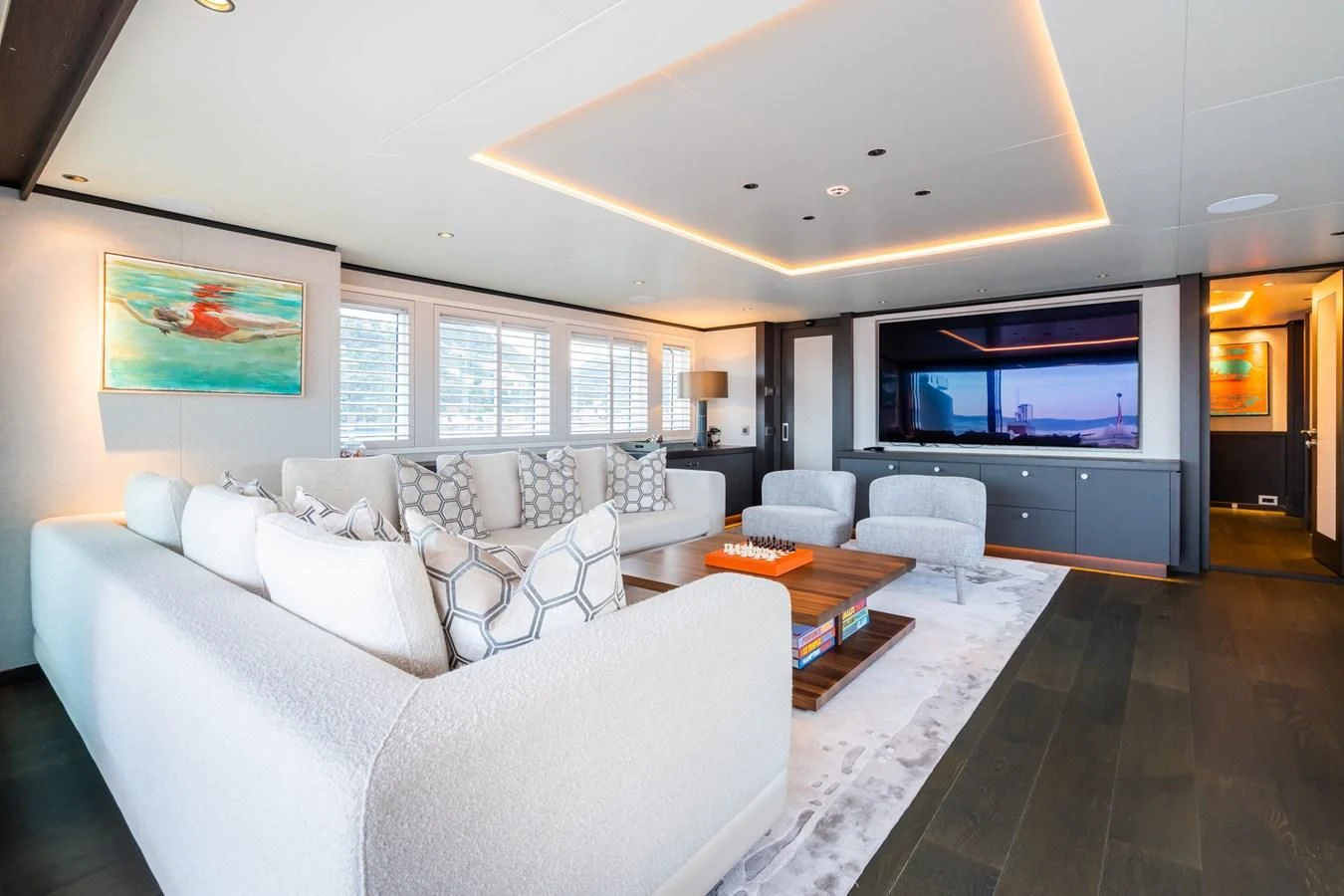 a living room with a large screen aboard EMERALD Yacht for Charter