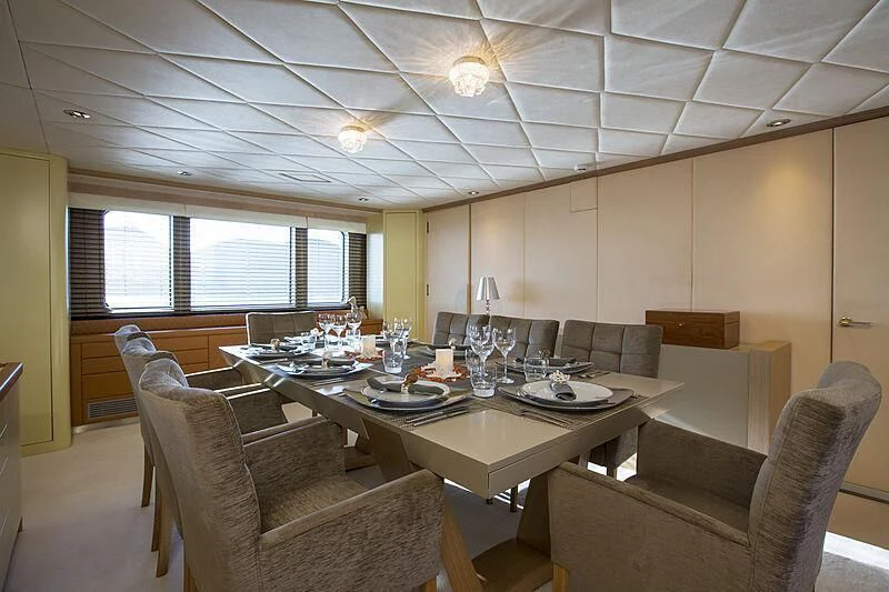 a room with a table chairs and a window aboard EMERALD Yacht for Charter