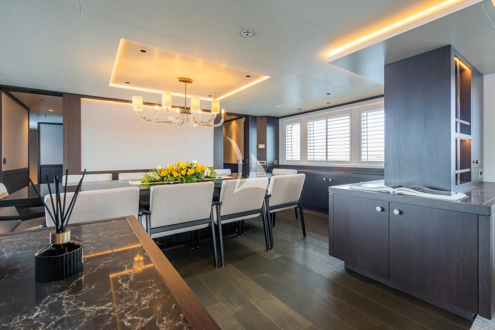 a large room with a table and chairs aboard EMERALD Yacht for Charter
