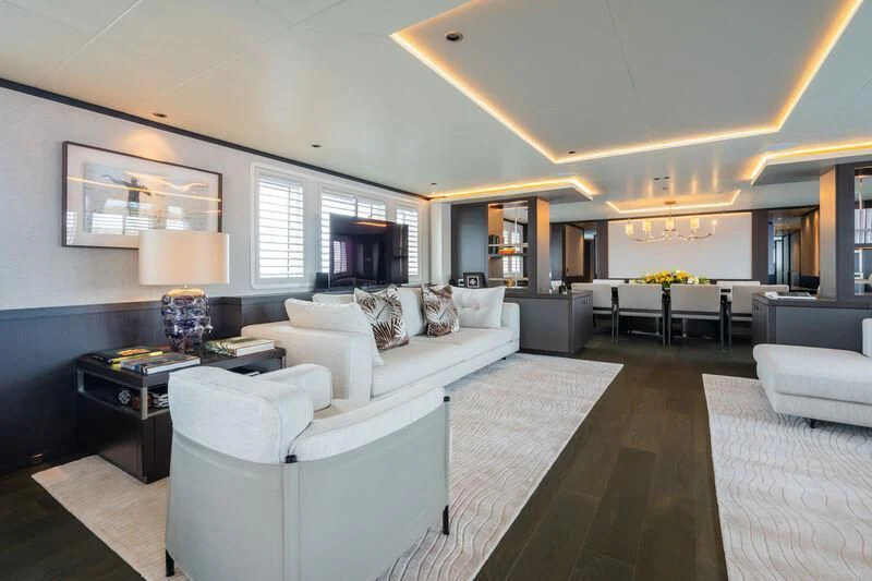 a living room with white couches aboard EMERALD Yacht for Charter
