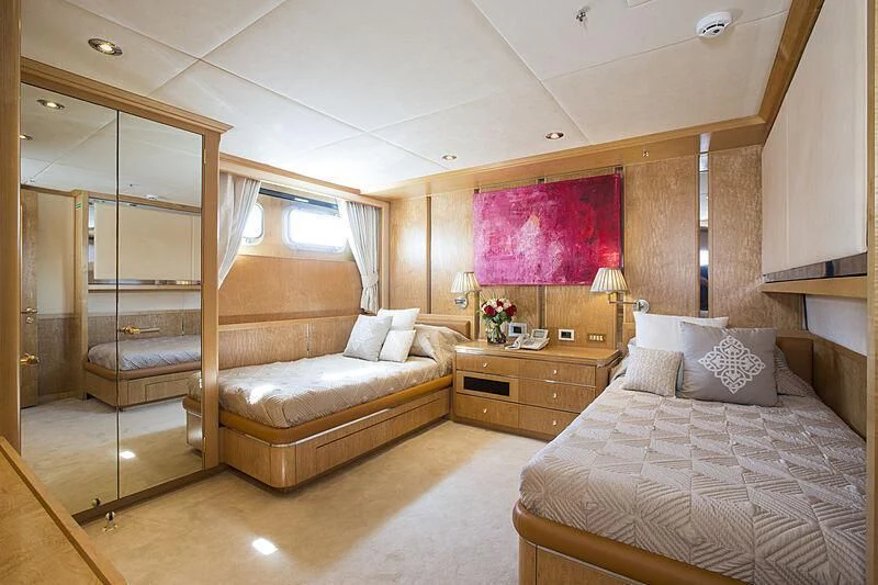 a bedroom with a bed and a mirror aboard EMERALD Yacht for Charter