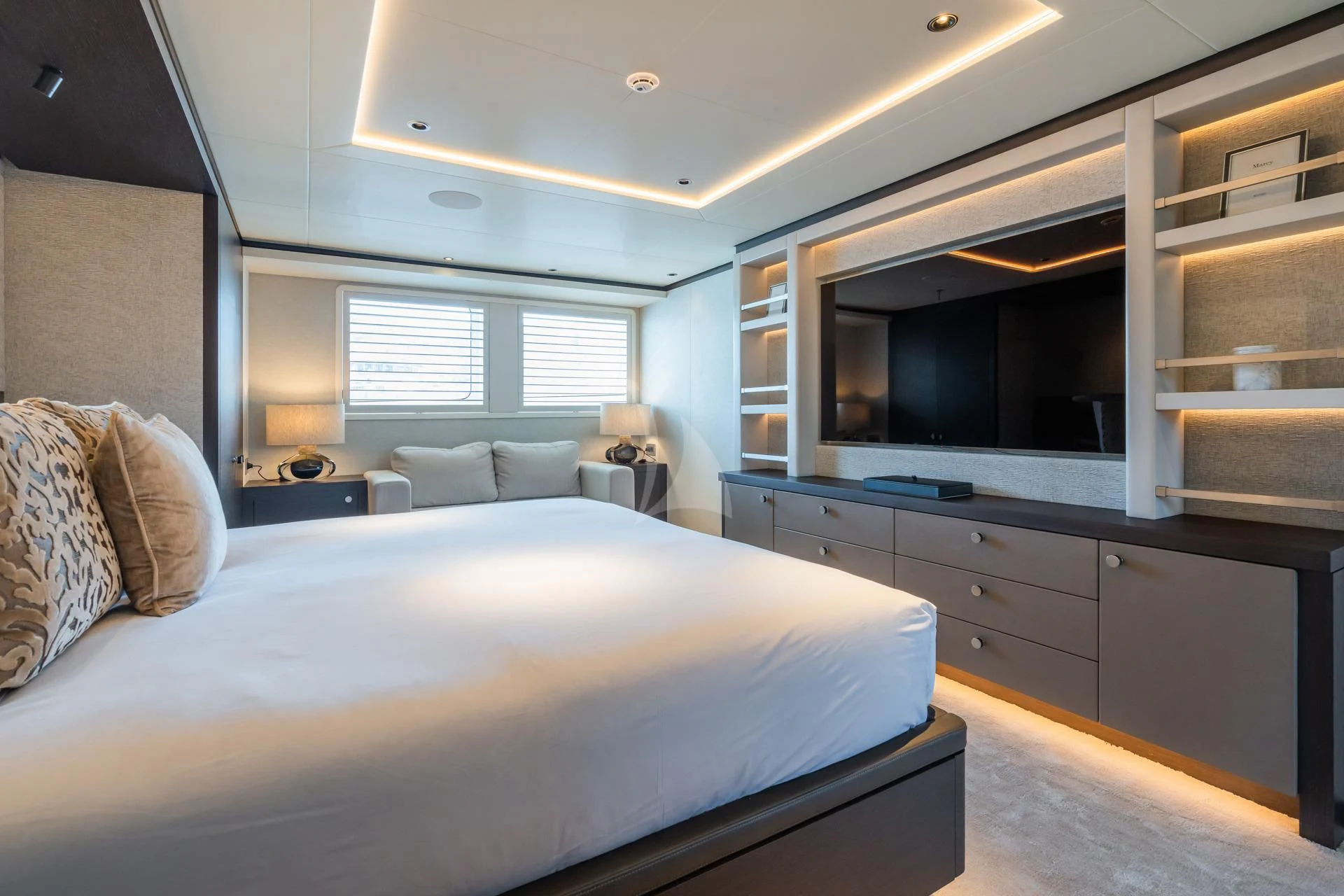 a bedroom with a bed and a tv aboard EMERALD Yacht for Charter