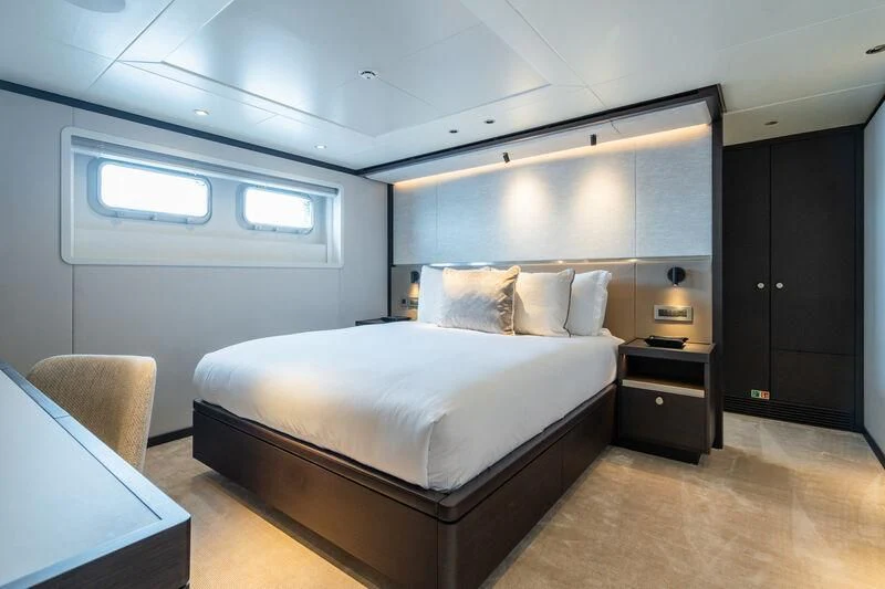 a bedroom with a bed and a desk aboard EMERALD Yacht for Charter