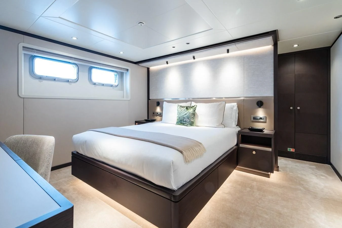 a bedroom with a bed and a desk aboard EMERALD Yacht for Charter