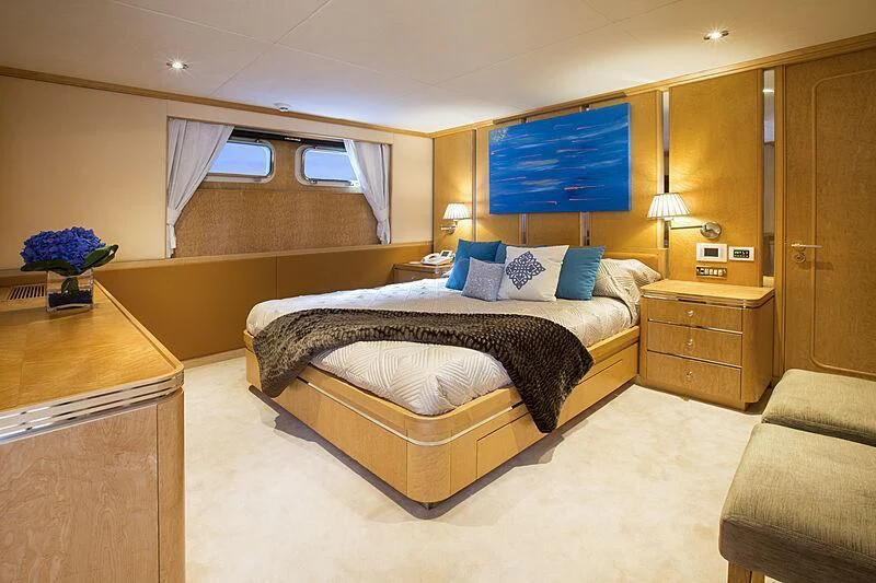 a bedroom with a bed and a desk aboard EMERALD Yacht for Charter