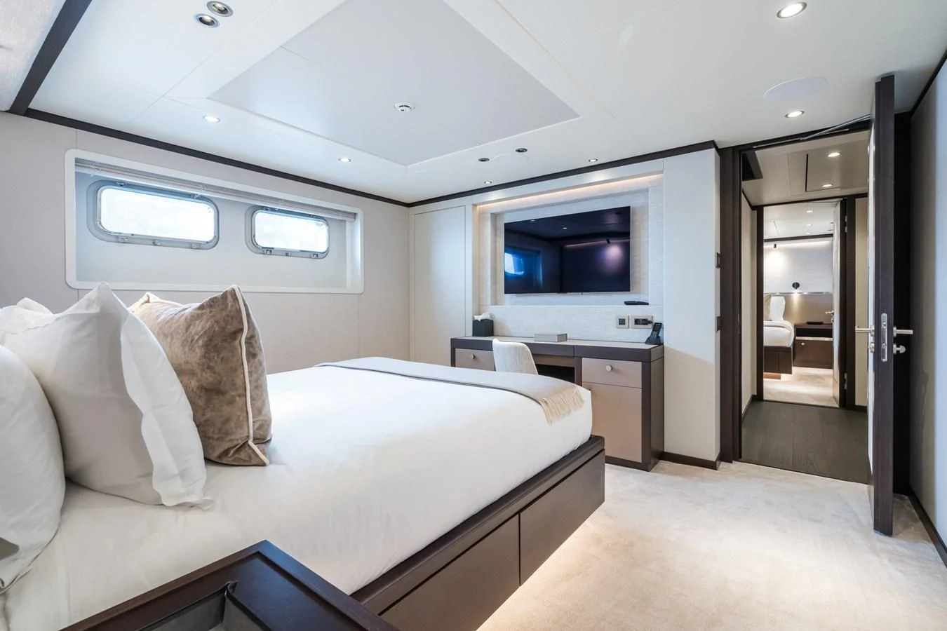 a bedroom with a bed and a tv aboard EMERALD Yacht for Charter