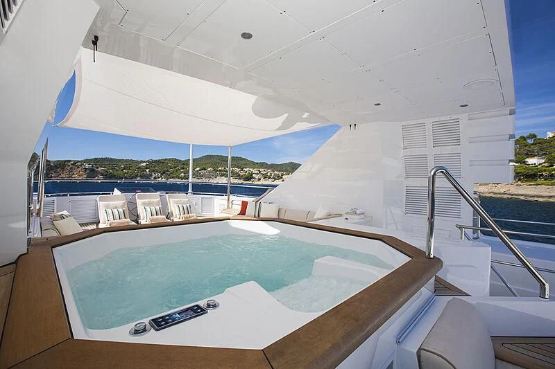a pool with a deck and chairs aboard EMERALD Yacht for Charter