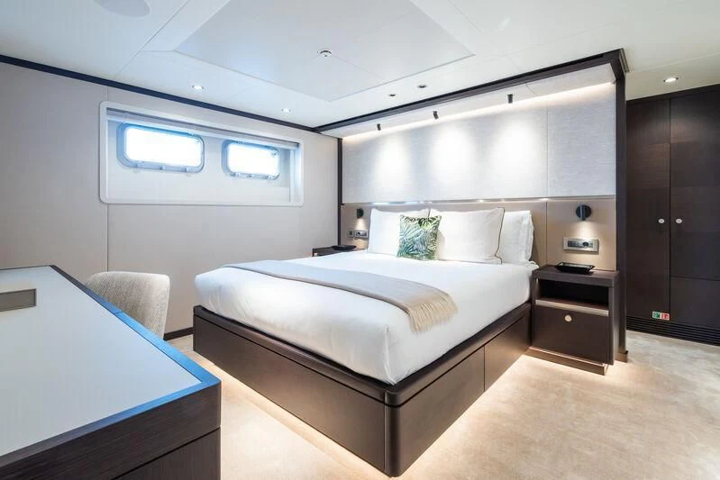 a room with a bed and a desk aboard EMERALD Yacht for Charter